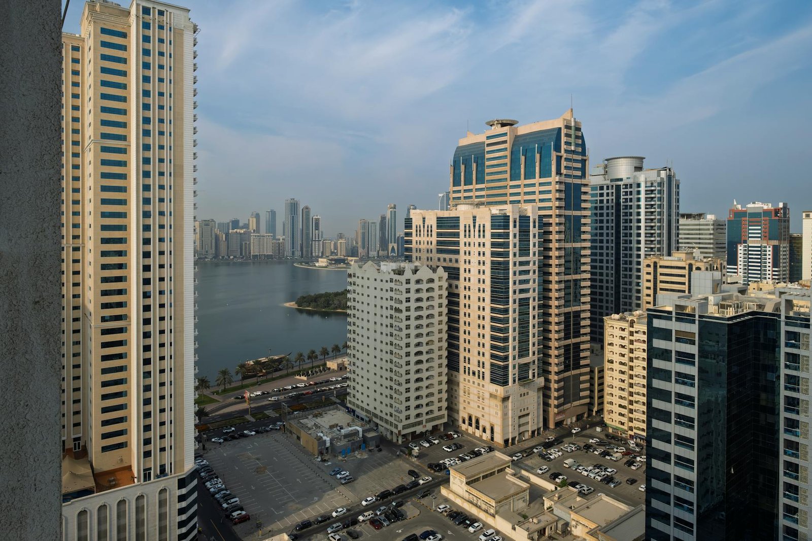 Aerial view of high-rise buildings and cityscape in Sharjah, UAE, showcasing urban architecture.