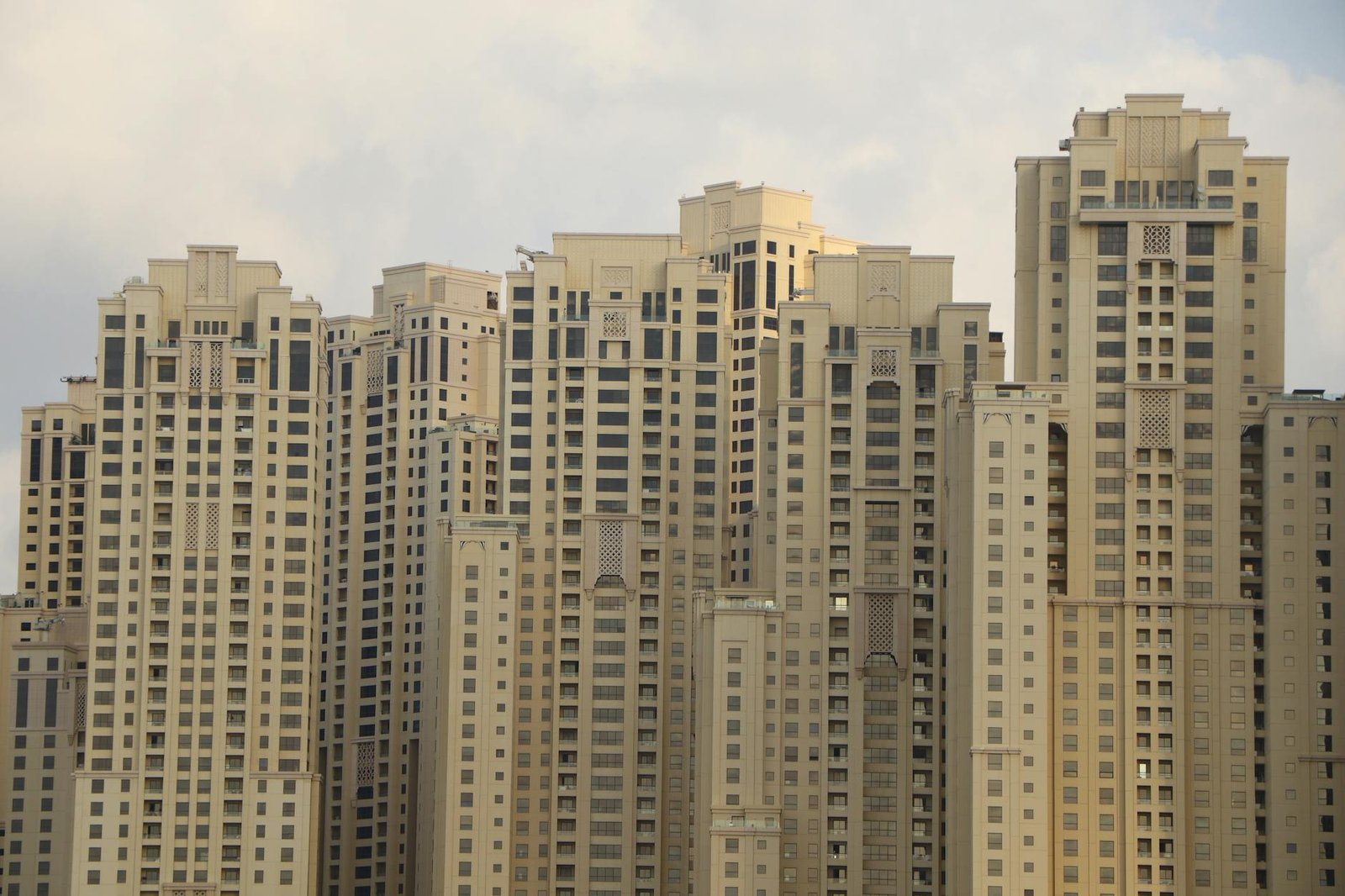 Tall residential skyscrapers characterize the iconic skyline of Dubai Marina, UAE.