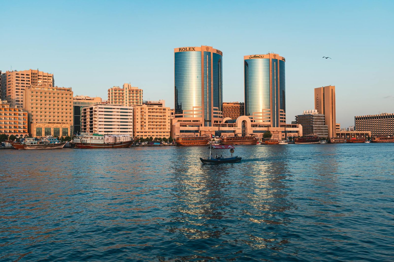 A breathtaking sunset view of the Deira Twin Towers and surrounding buildings in Dubai, UAE.
