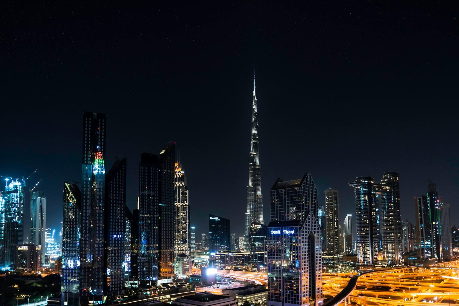 Stunning nighttime view of Dubai's skyline with the iconic Burj Khalifa illuminated under a starry sky.